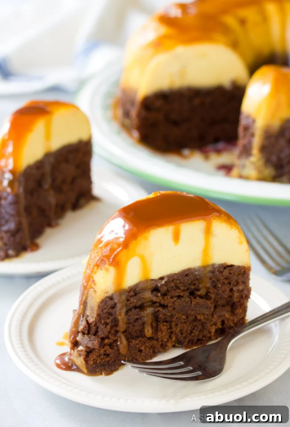 Multiple slices of Chocoflan Impossible Cake served on individual plates, with the remaining cake visible in the background, highlighting its delicious layers and caramel.