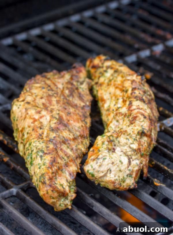 A perfectly cooked pork tenderloin, showcasing the results of the 7-6-5 grilling method, sliced and ready to serve.