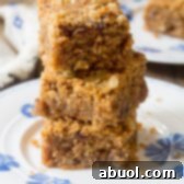 A perfectly baked Egg-Free Oatmeal Bar, ready for a healthy breakfast or snack. #GlutenFree #Vegan #HealthyBreakfast