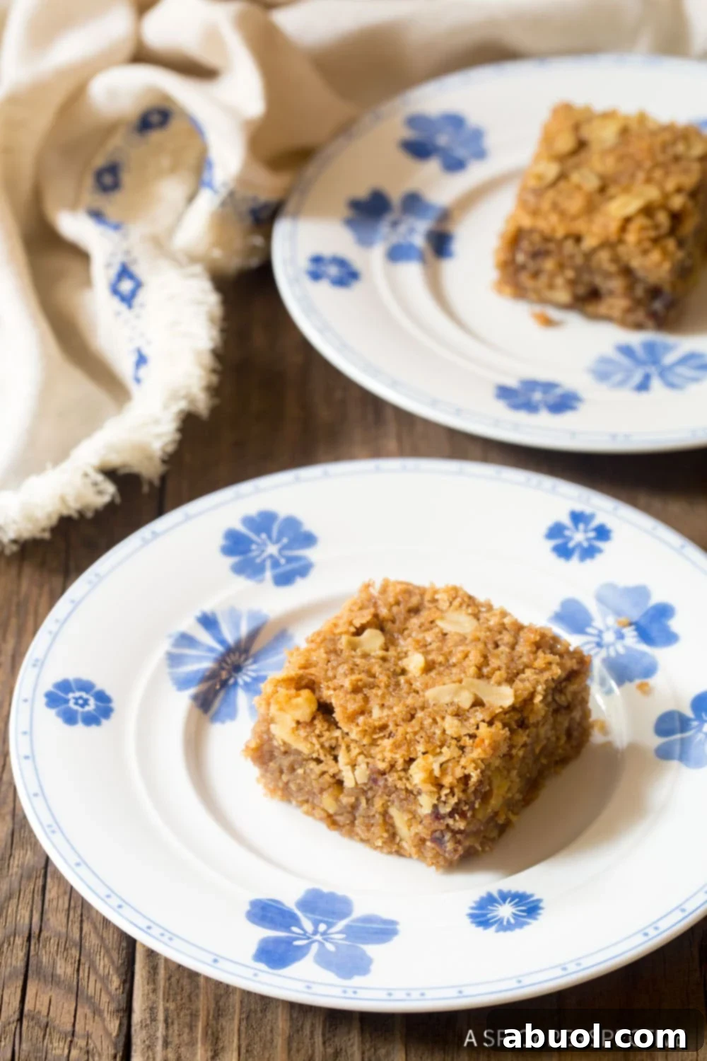 Delicious and healthy breakfast oatmeal bars arranged on a blue and white patterned plate, ready to be enjoyed.