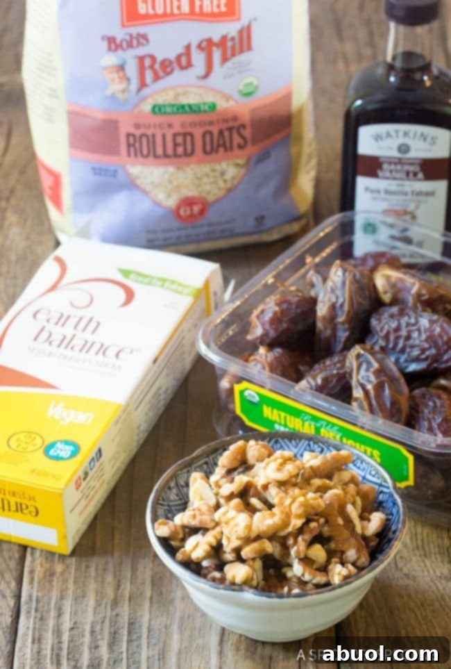 All the dry and wet ingredients for oat breakfast bars laid out on a wooden table, ready for preparation.