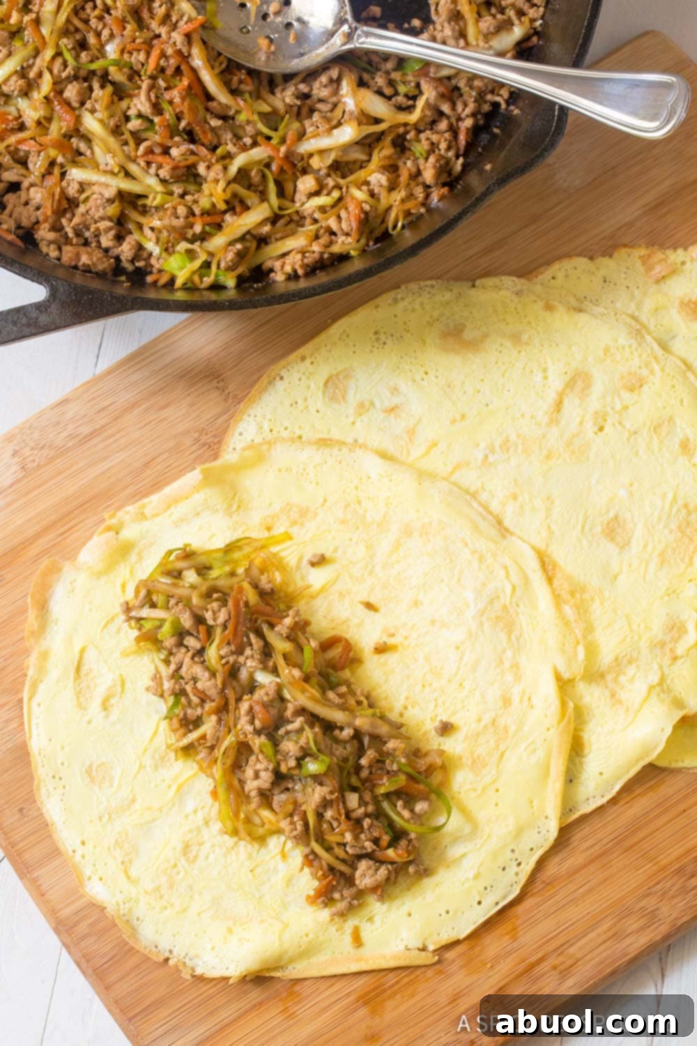 Low Carb Egg Roll Wraps - Filling portioned on egg wrappers, ready to roll