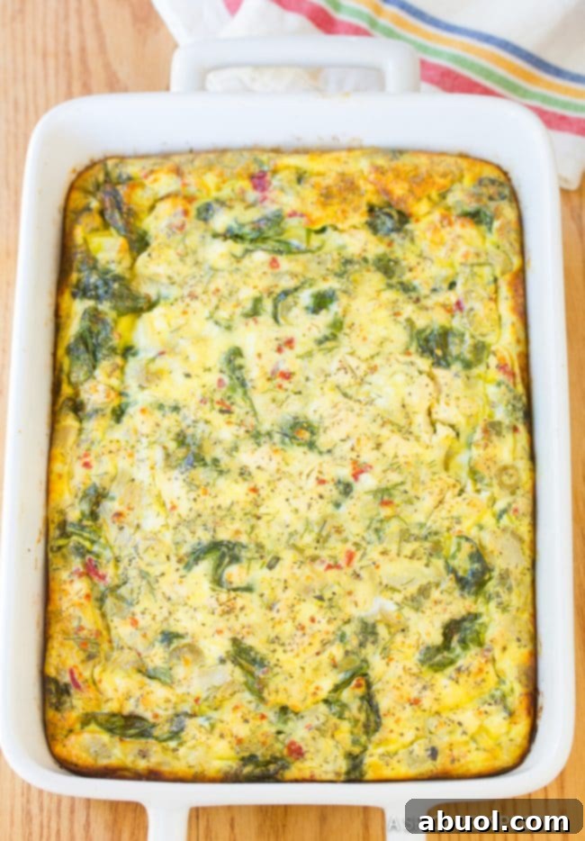Freshly baked Greek omelette casserole in a casserole dish, golden brown and perfectly set.