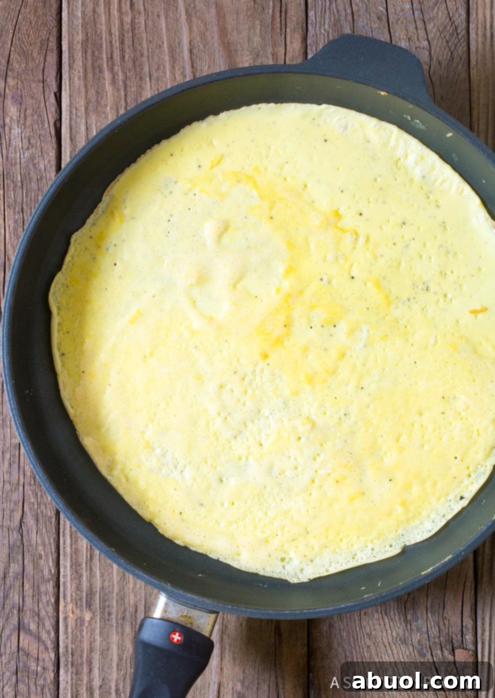 Making an egg tortilla in a nonstick skillet.