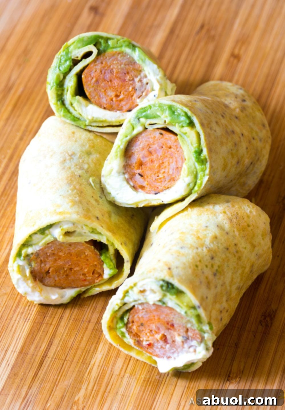 Breakfast egg wraps cut in half and stacked on top of each other, revealing the delicious filling.