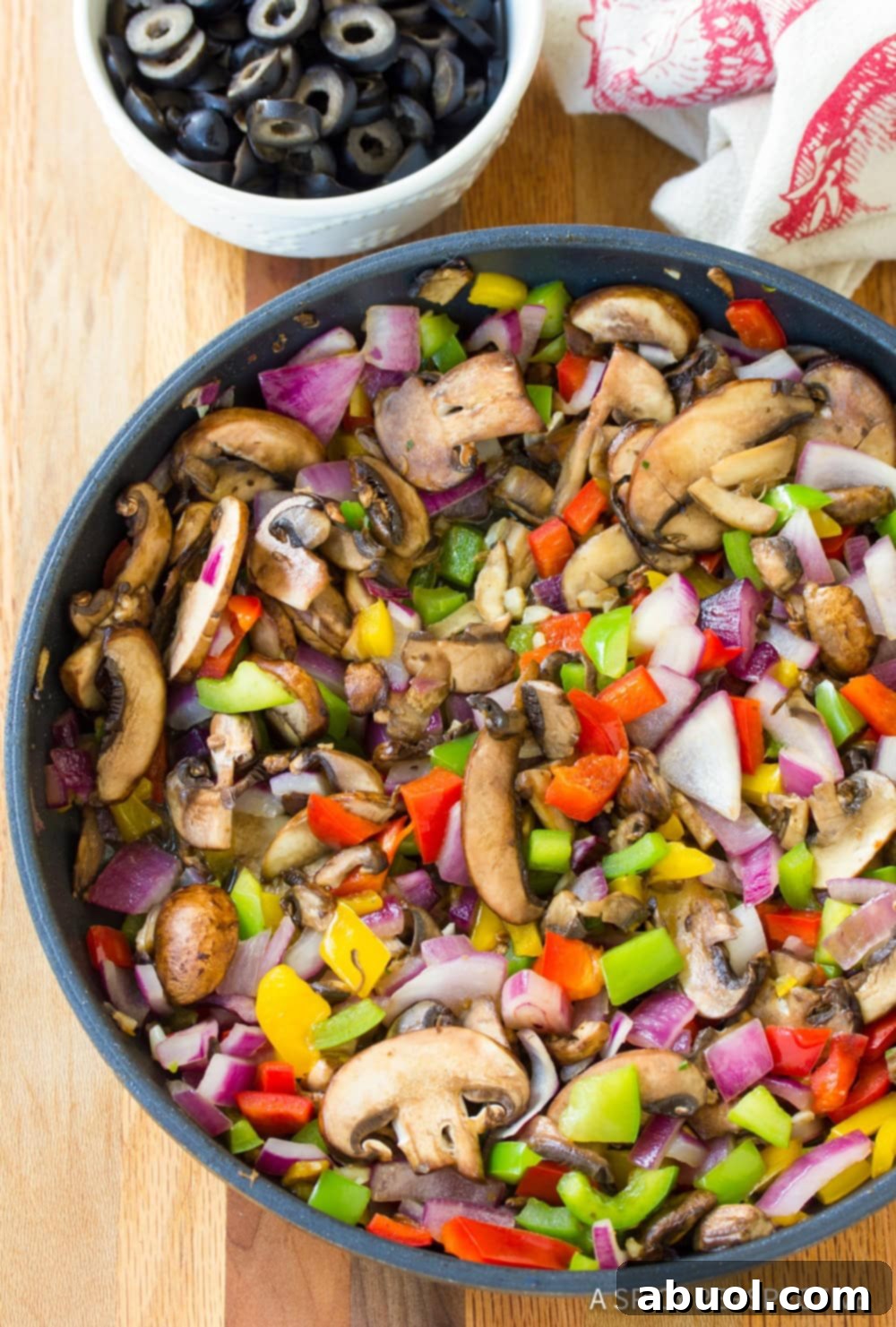 Epic Pizza Lasagna Fusion 4 Chopped bell peppers, onions, mushrooms, and garlic sautéing in a skillet.