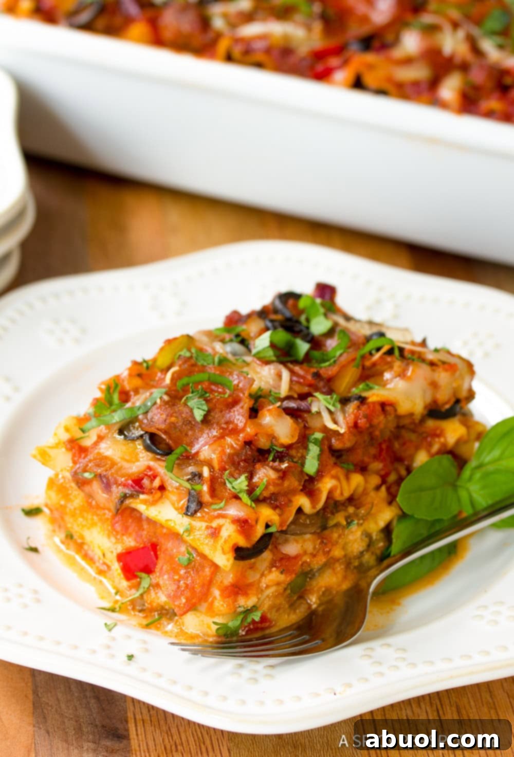 Epic Pizza Lasagna Fusion 7 A perfectly sliced piece of Supreme Pizza Lasagna on a plate, showing all the delicious layers.