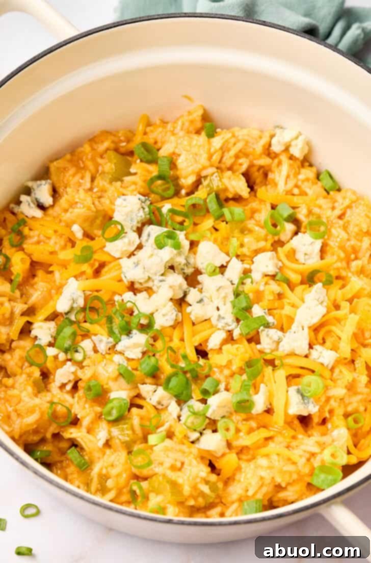 Buffalo Chicken and Rice Casserole Recipe in pot with scallions and cheese