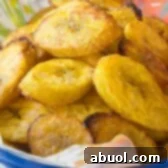 The Perfect Baked Plantains Recipe, showing a close-up of the delicious golden slices.