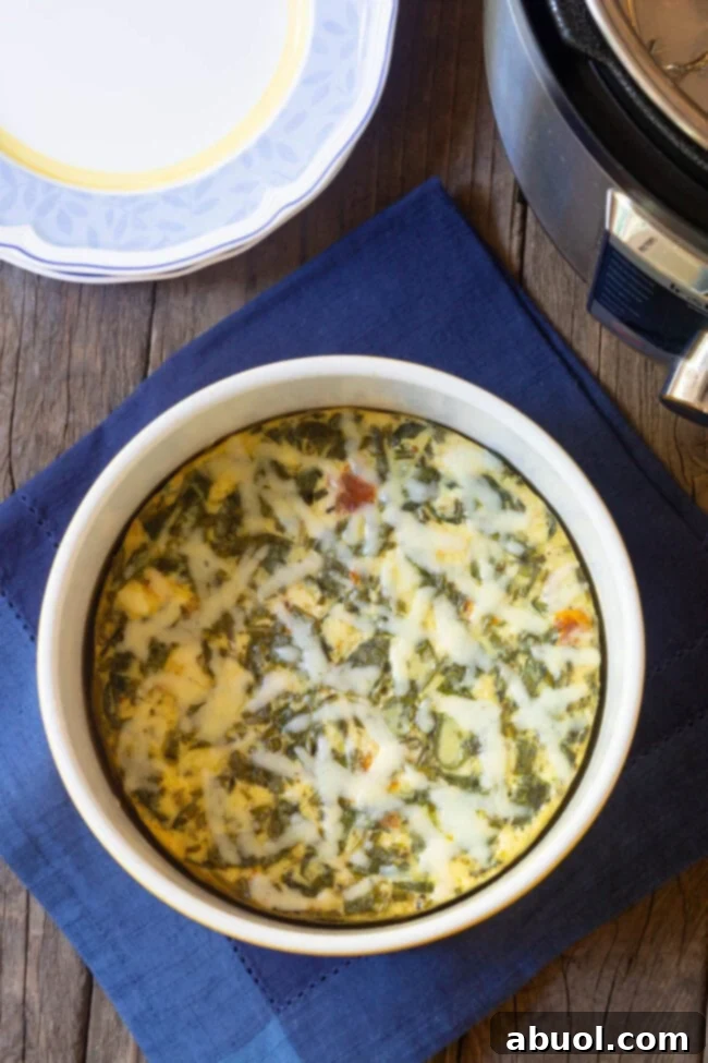 An overhead shot of a perfectly golden Instant Pot Keto Crustless Quiche in a pristine white souffle pan, ready to be served.