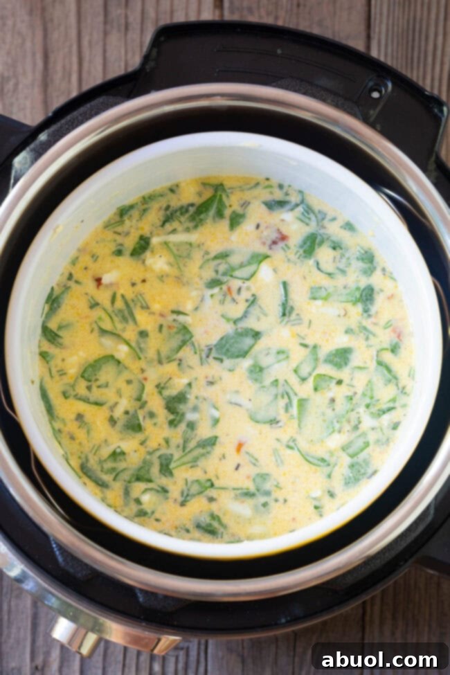 A soufflé dish filled with uncooked quiche mixture being carefully placed into an Instant Pot, resting on the trivet above the water.