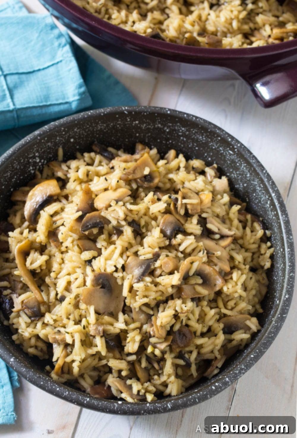 A beautifully presented bowl of Mushroom Rice Pilaf, showcasing the rich texture and vibrant colors of the mushrooms and herbs nestled within the fluffy rice.