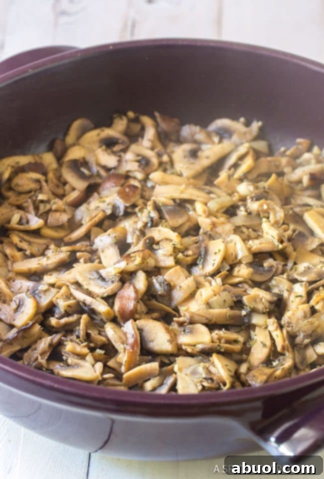 Golden-brown sautéed mushrooms glistening in a pan, their rich aroma filling the kitchen as they soften and develop deep umami flavors.