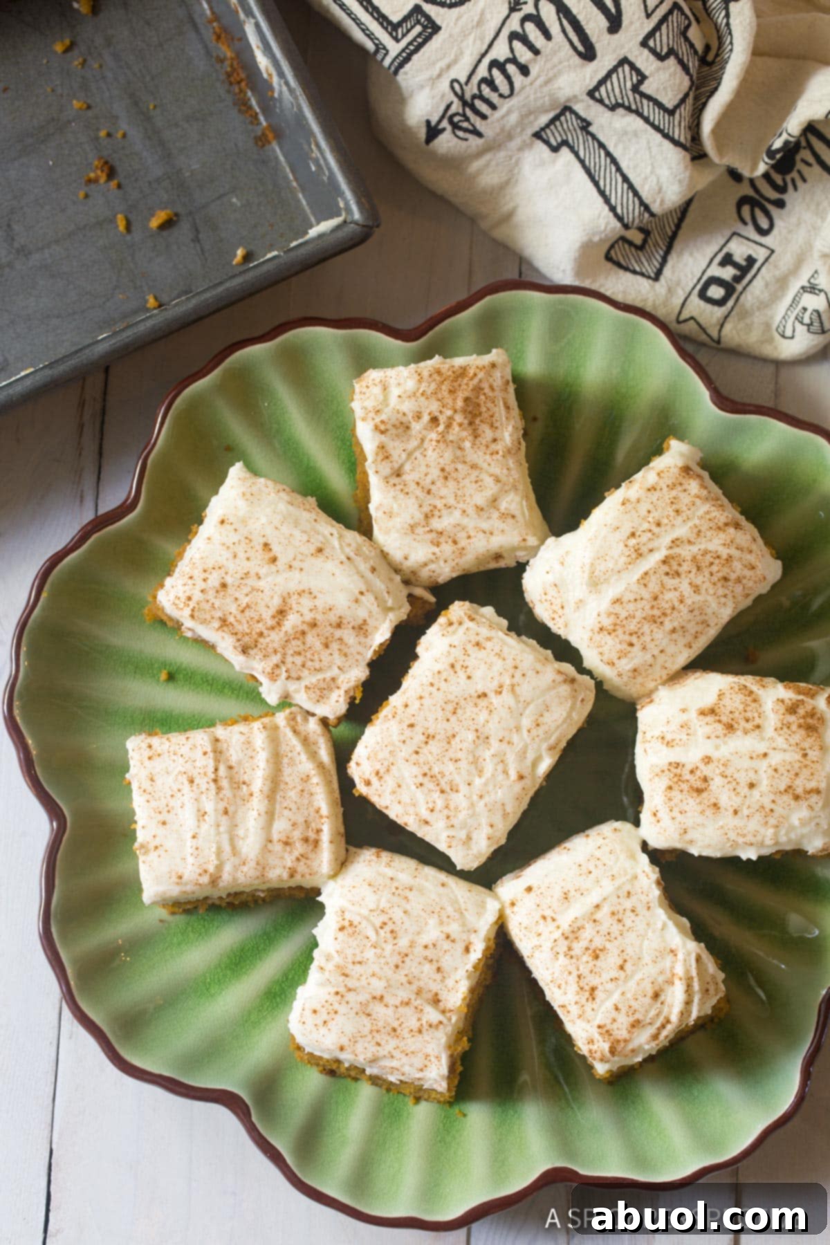 Golden Harvest Pumpkin Sheet Cake 4 Perfect Pumpkin Texas Sheet Cake with Buttermilk Frosting Recipe - overhead shot of cake pieces on platter