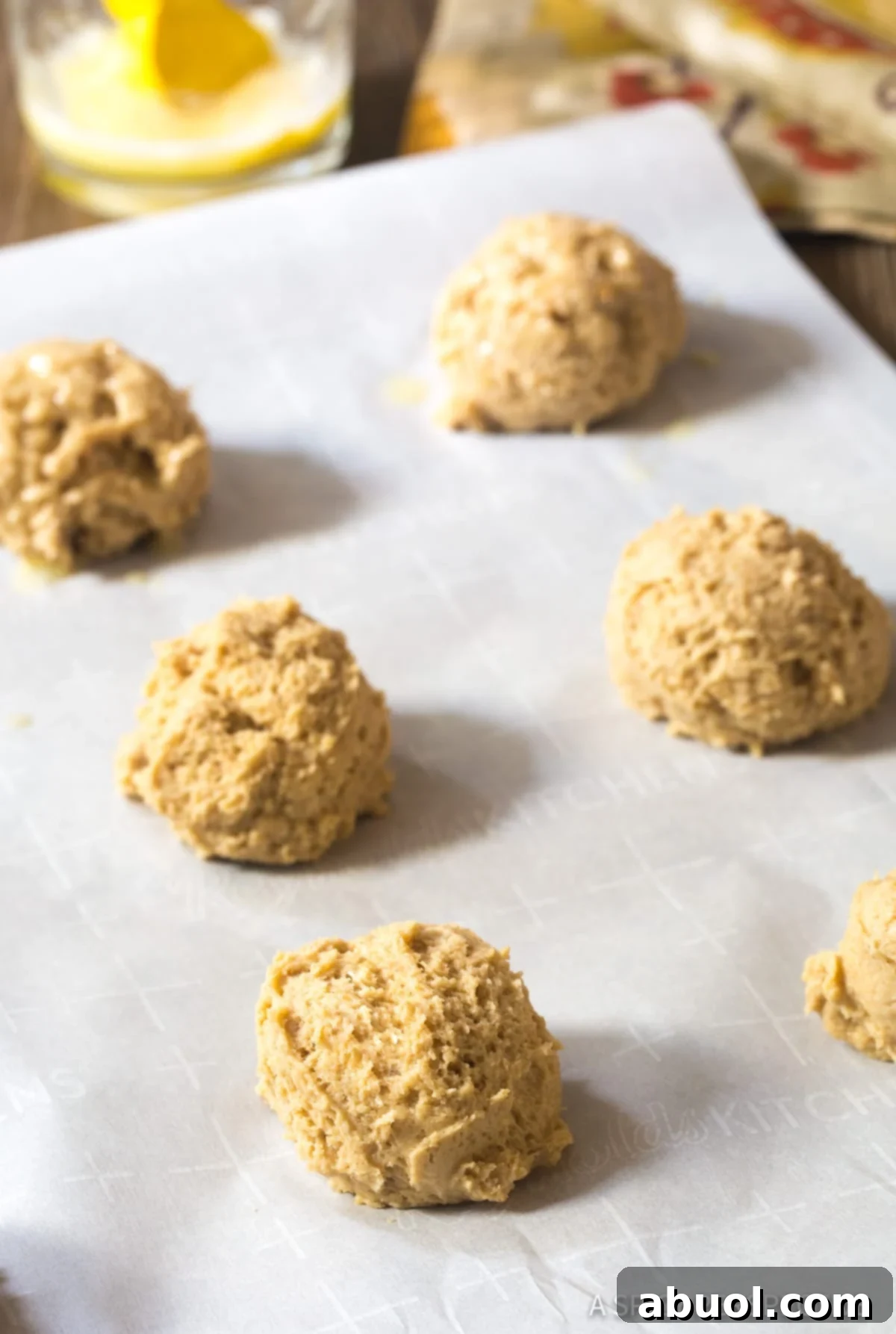 Unbaked Cinnamon Drop Biscuits dough on baking sheets, brushed with butter and perfectly arranged, ready for the oven