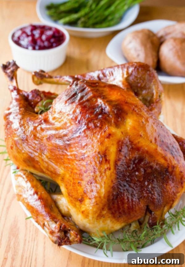 A majestic roast turkey presented on a serving platter, garnished with fresh herbs, showcasing the success of a well-executed Turkey Brine Recipe.