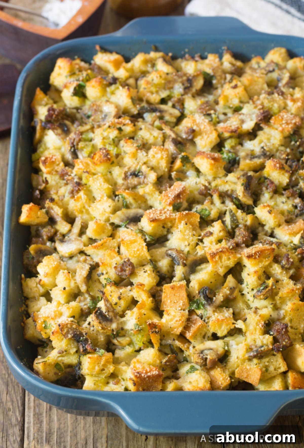 Savory Sausage & Wild Mushroom Stuffing 3 Sausage Mushroom Thanksgiving Stuffing Recipe in casserole dish with golden brown top.