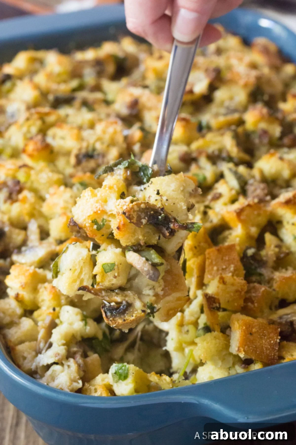 Savory Sausage & Wild Mushroom Stuffing 4 Best Sausage Mushroom Stuffing Recipe, spooned up with serving spoon.