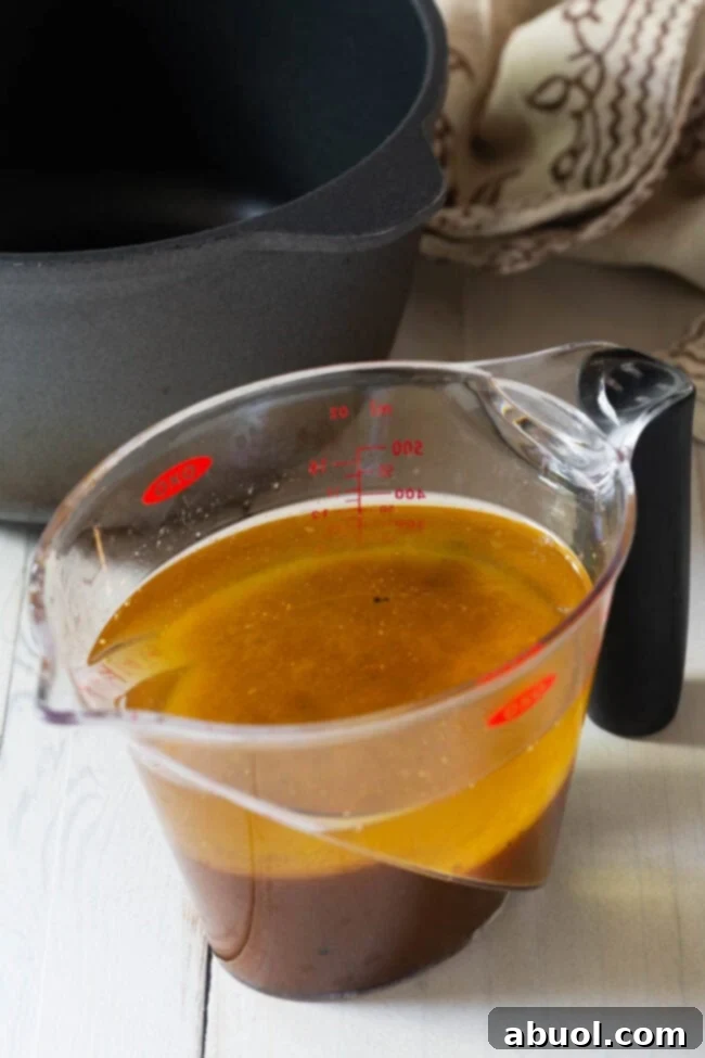 The Ultimate Turkey Gravy 5 Ingredients for homemade turkey gravy being measured out, including turkey drippings.