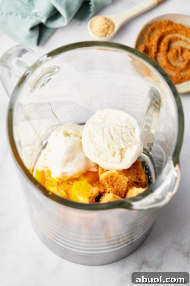 Pumpkin shake ingredients being blended together in a high-speed blender, creating a smooth and creamy mixture.