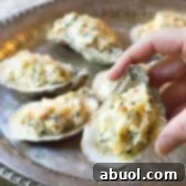 Three-Cheese Baked Oysters Recipe, a perfect holiday appetizer with cheese and bacon.