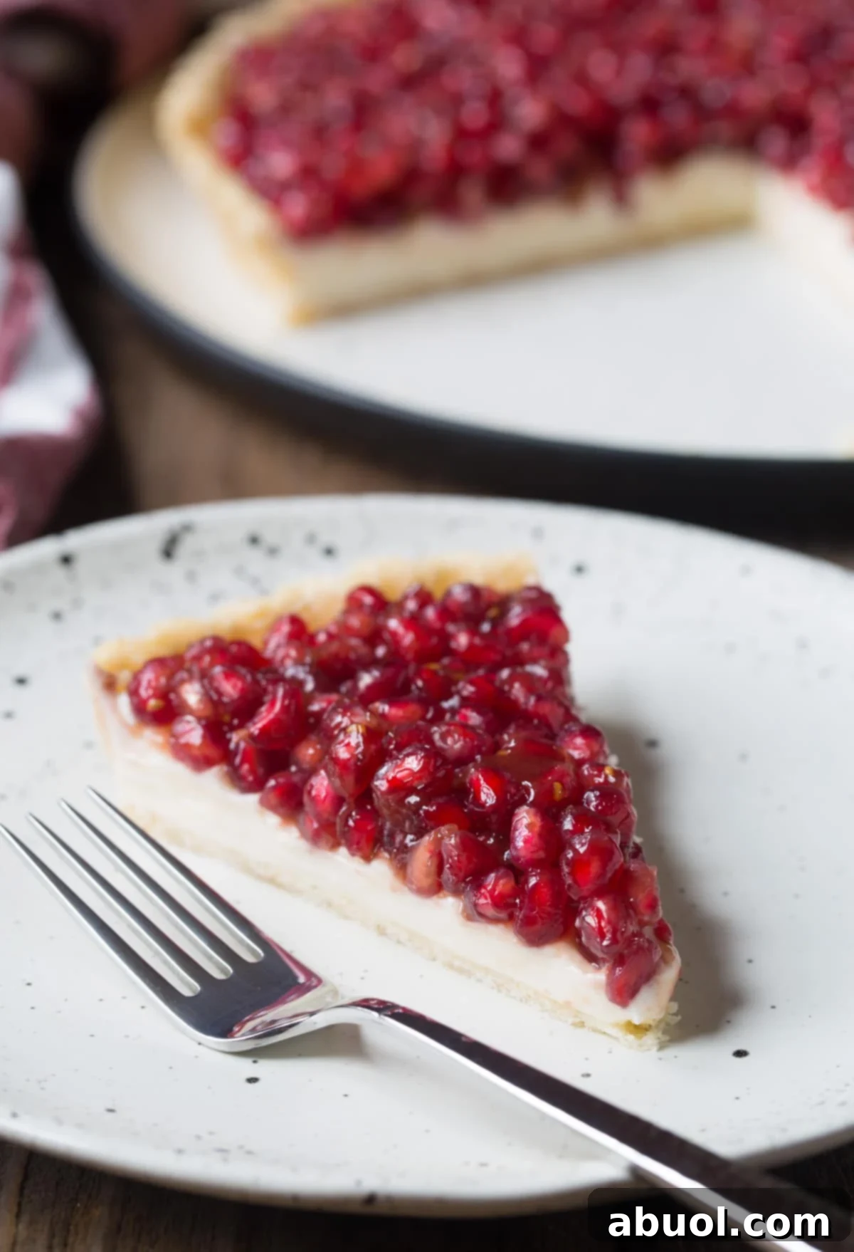 Easy 6-Ingredient Pomegranate Tart Recipe - cut on plate with fork