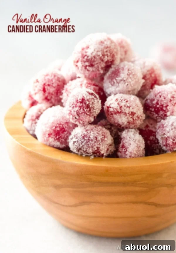 Sparkling Vanilla Orange Candied Cranberries Recipe in a wooden bowl, glistening with sugar