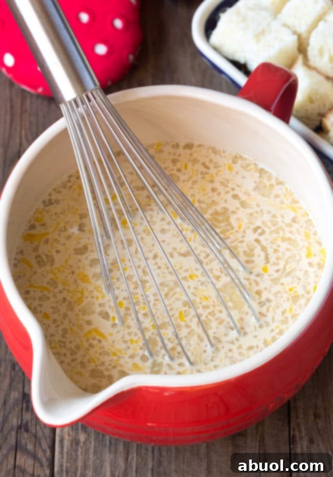 Coffee Bread Pudding ingredients whisked in a mixing bowl.