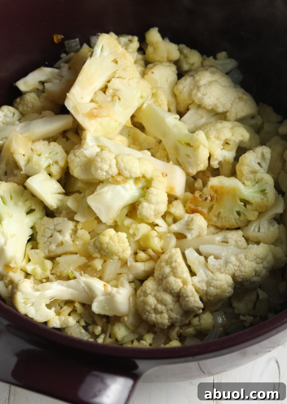 Cauliflower Soup Recipe - Chopped cauliflower and onions in soup pot.