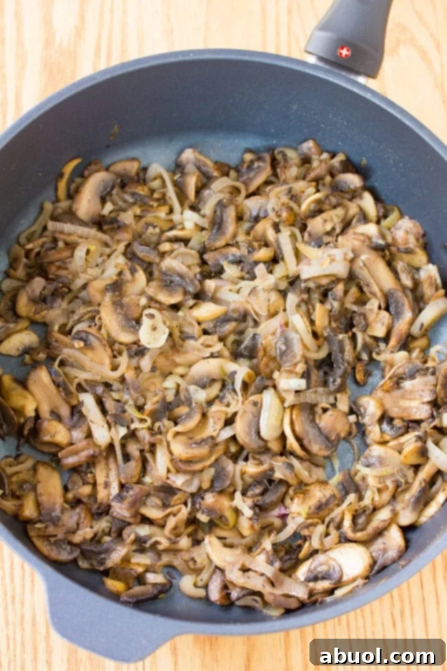 Gourmet Salmon En Croute 5 Close-up of sautéed mushrooms, a key filling for Salmon Coulibiac