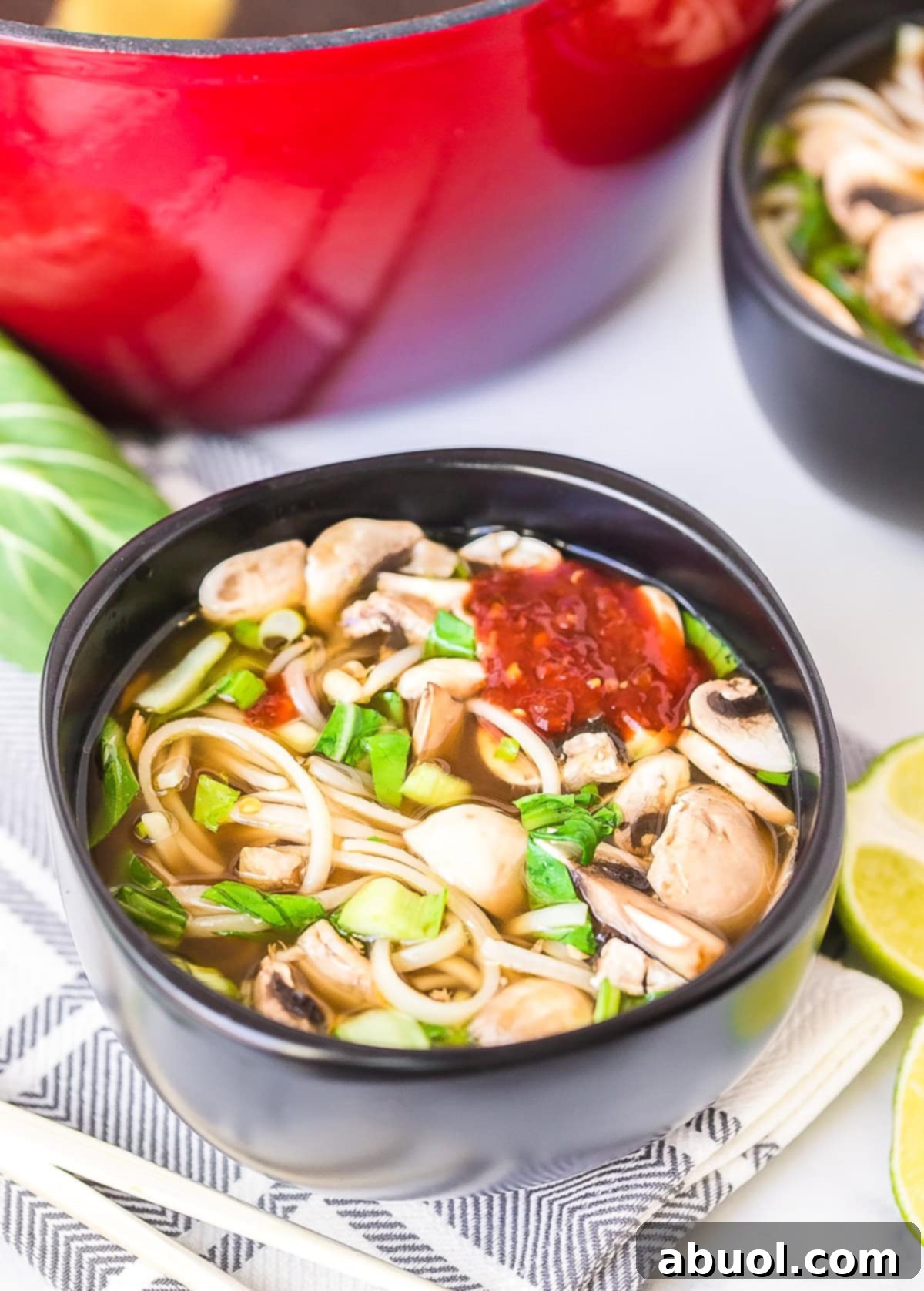 A steaming bowl of Chinese Chicken Hot Pot, showcasing rich broth, tender chicken, an assortment of fresh vegetables, and delicate bean thread noodles.
