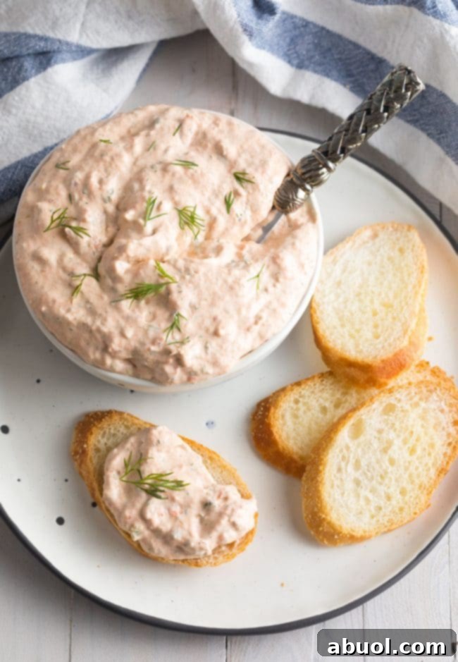 Creamy Smoked Salmon Dip 2 Small pieces of toasted bread with creamy smoked salmon dip on the tip, garnished with fresh dill.