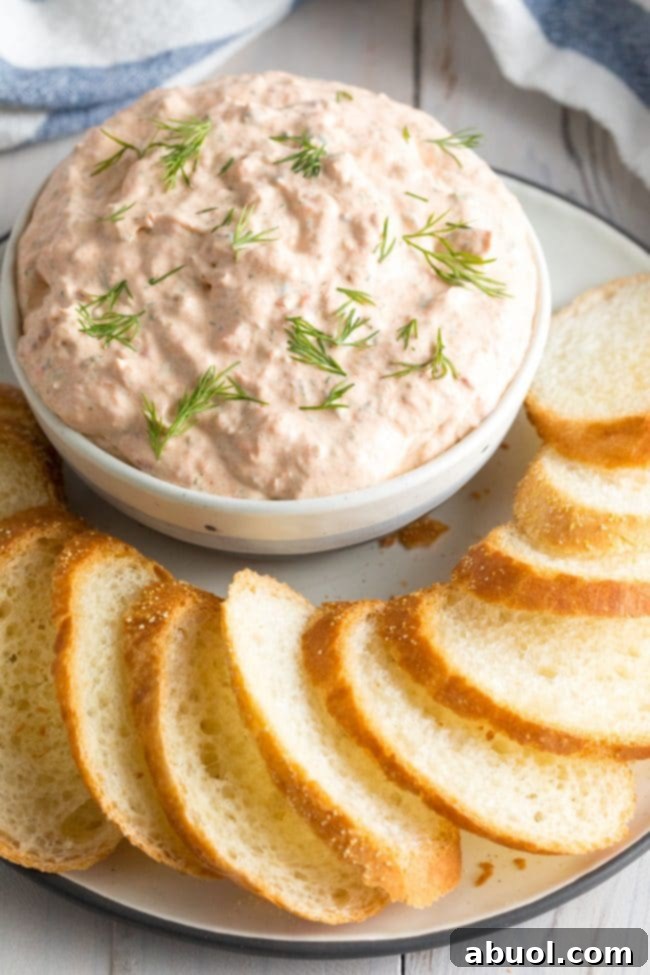 Creamy Smoked Salmon Dip 6 Small bowl of smoked fish dip garnished with fresh dill and served with toasted bread slices around it.