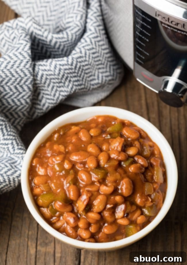 Top view of bowl with pinto beans in front of large Pressure Cooker