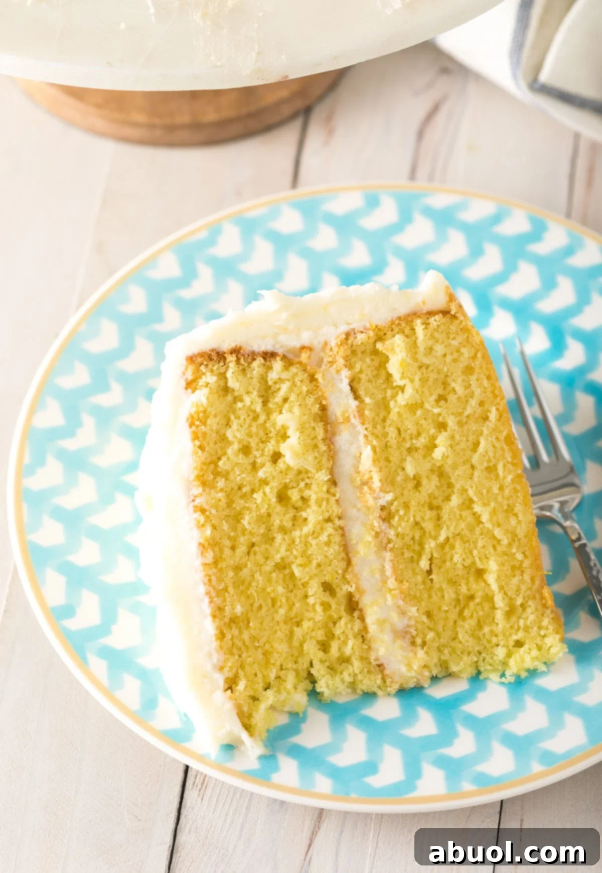 A slice of Lemon Buttermilk cake on a blue plate.