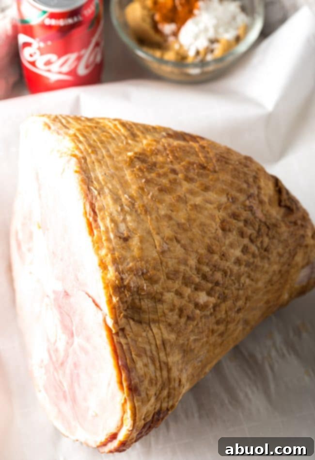 A whole spiral-cut ham on a baking sheet, before any glaze has been applied.