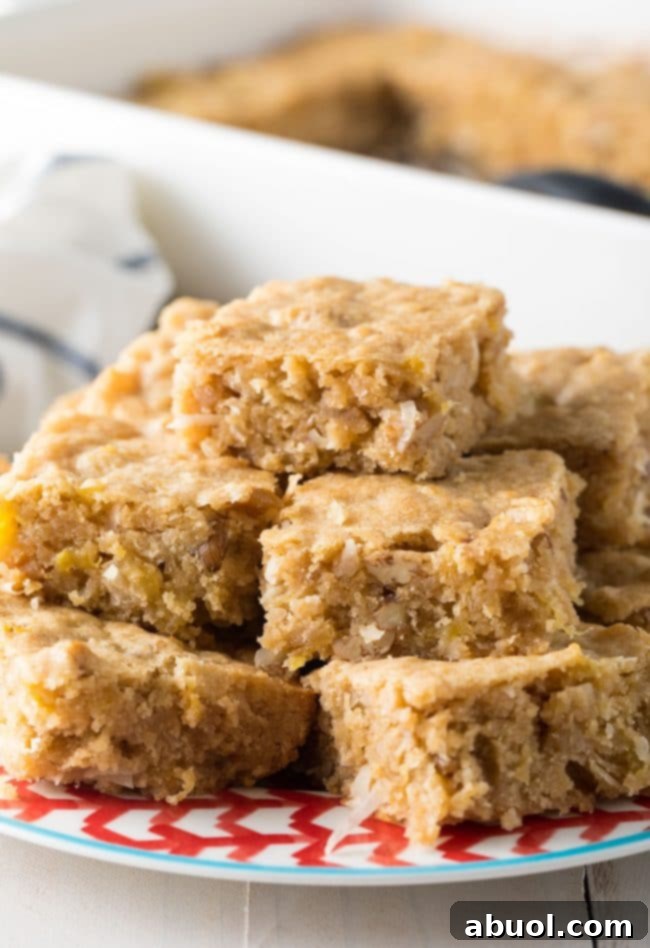 Pina Colada Blondies 2 Hummingbird blondies cut into bars and served on a plate.