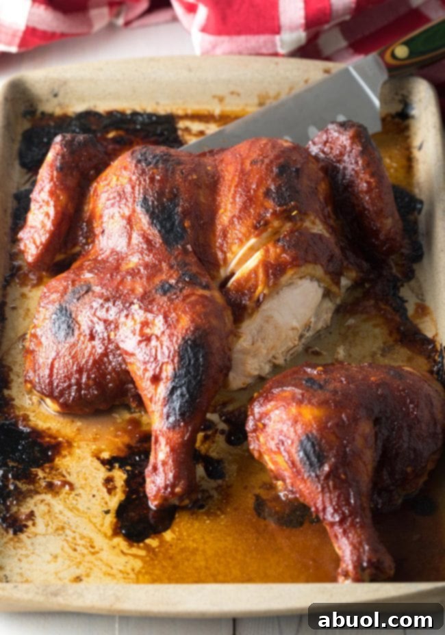Slicing a perfectly cooked Coca Cola Spatchcock Chicken.