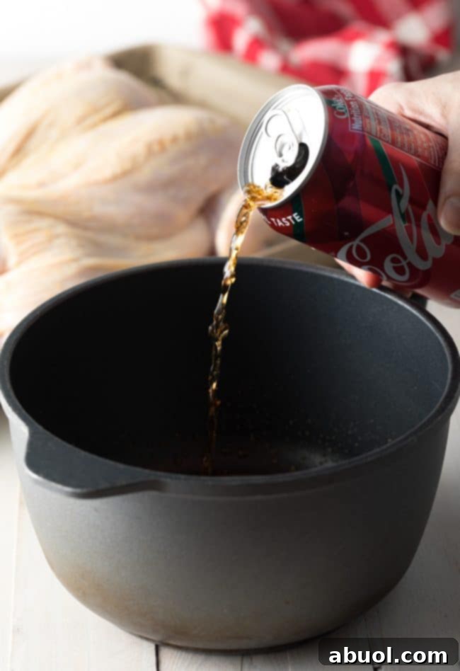 Pouring cola coca into a pan with other ingredients to make the sauce.