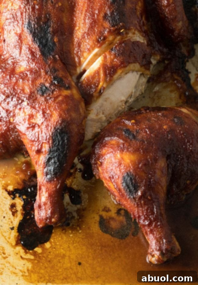 Coca cola chicken - partially sliced, showing juicy interior.