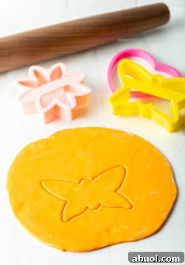 Homemade Fondant Magic 12 A clean cookie cutter pressed into a sheet of marshmallow fondant, ready to create decorative shapes.
