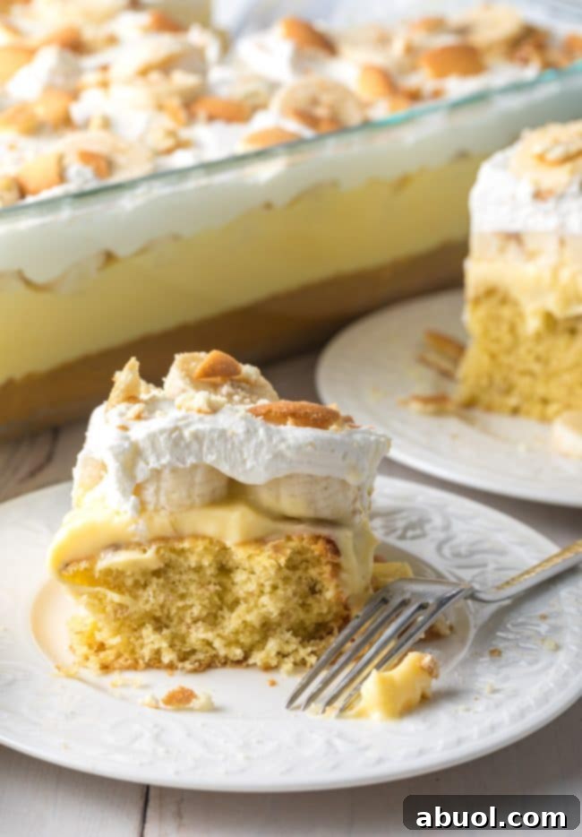 Decadent Banana Pudding Cake 12 Best banana pudding cake slice on a plate next to another plate with cake on it, too.