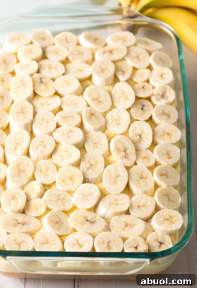 Decadent Banana Pudding Cake 7 Fresh banana slices on top of the pudding layer in the banana pudding cake.
