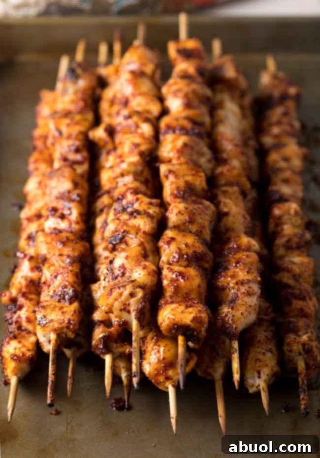 Another step-by-step image, showing chicken skewers being threaded.