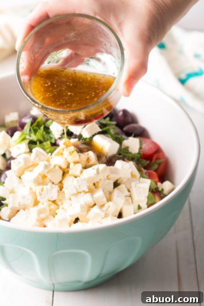 Best Greek Horiatiki (Village Salad) Recipe - The finished salad, beautifully presented and ready to be served in a rustic bowl.