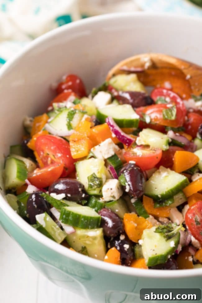 Perfect Greek Horiatiki (Village Salad) Recipe - A vibrant, healthy side dish or light meal served on a wooden board.