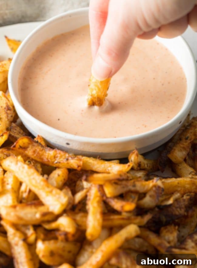 Low Carb Baked Turnip Fries Recipe dunked in sauce