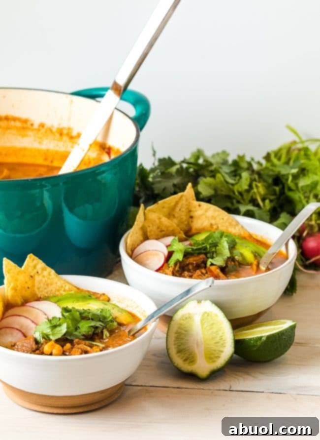 Mexican-Red-Posole-Recipe-with-Pork Pozole Rojo bowls served with lime wedges