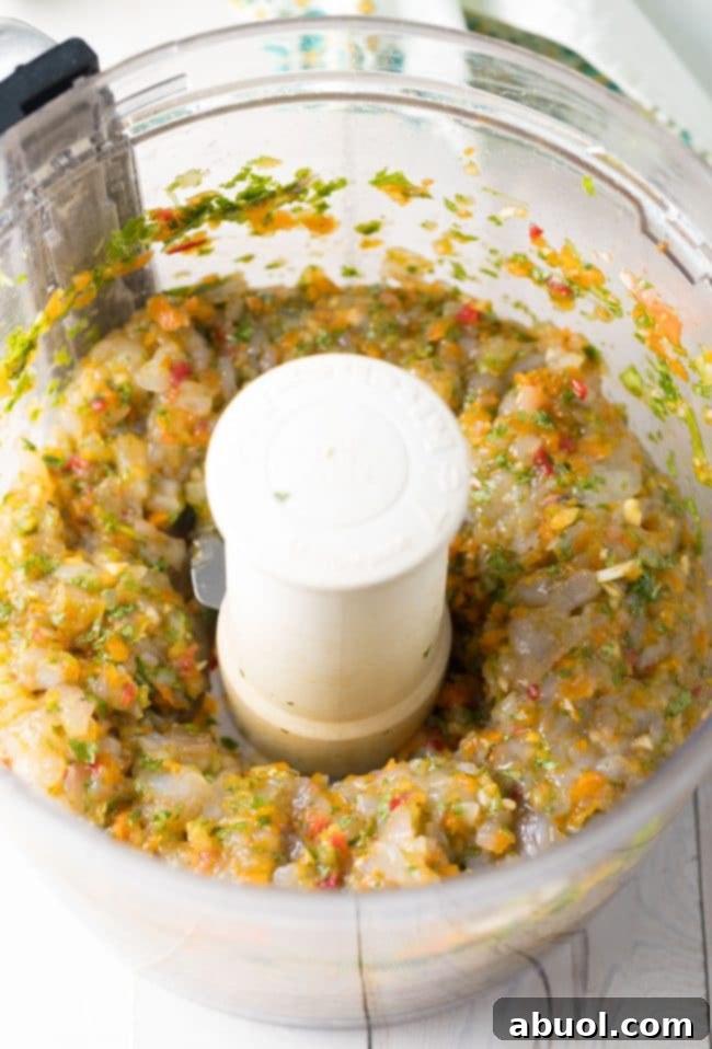 Gourmet Shrimp Burgers 8 Mixing the shrimp and finely chopped ingredients to form the Caribbean Shrimp Burger patties.