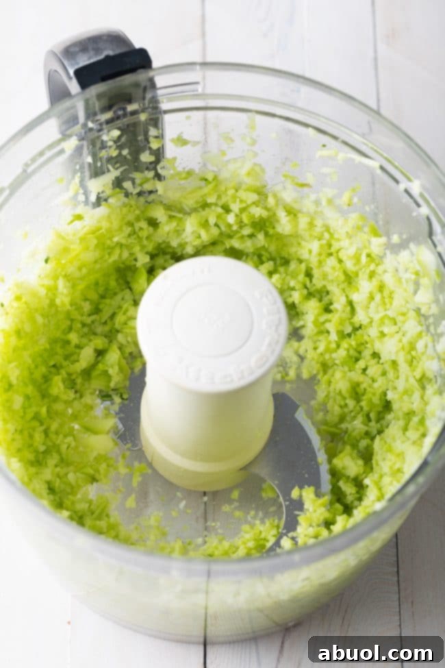 A detailed image capturing the finely riced broccoli stalks, showcasing the perfect consistency before moving to the next step.